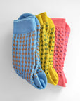 Hayes socks from Hooray Sock Co. Mid-crew length, textured ribbing, solid heel, toe, and contrasting color. In Mustard Yellow, Blue, Pink.