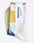 Hooray Sock Co. Lotus Crew Socks. Fun, lightweight, cozy with blue and gold lotus illustration. Crew length, 80% cotton, 20% spandex.