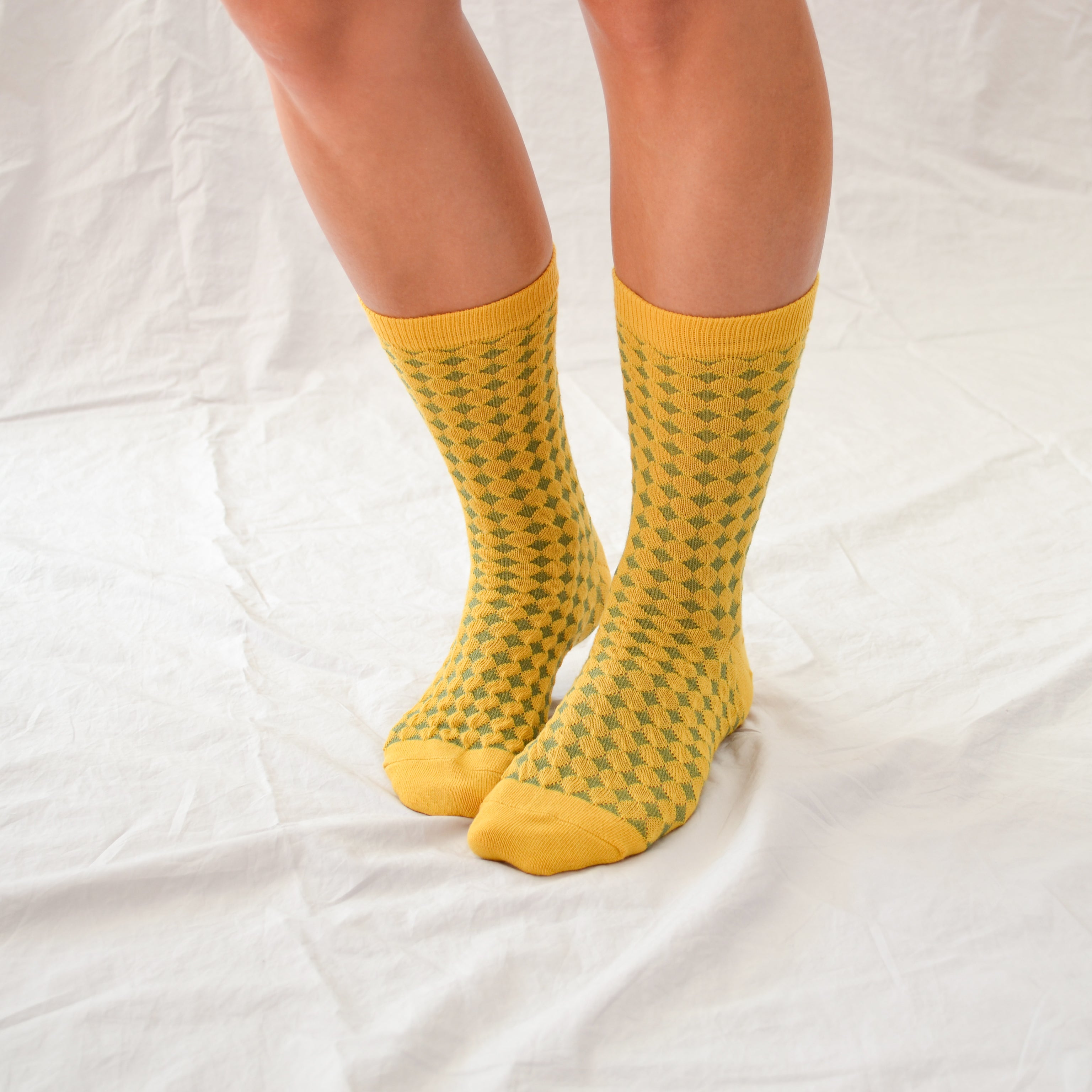 Hayes socks from Hooray Sock Co. Mid-crew length, textured ribbing, solid heel, toe, and contrasting color. In Mustard Yellow, Blue, Pink.