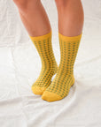 Hayes socks from Hooray Sock Co. Mid-crew length, textured ribbing, solid heel, toe, and contrasting color. In Mustard Yellow, Blue, Pink.