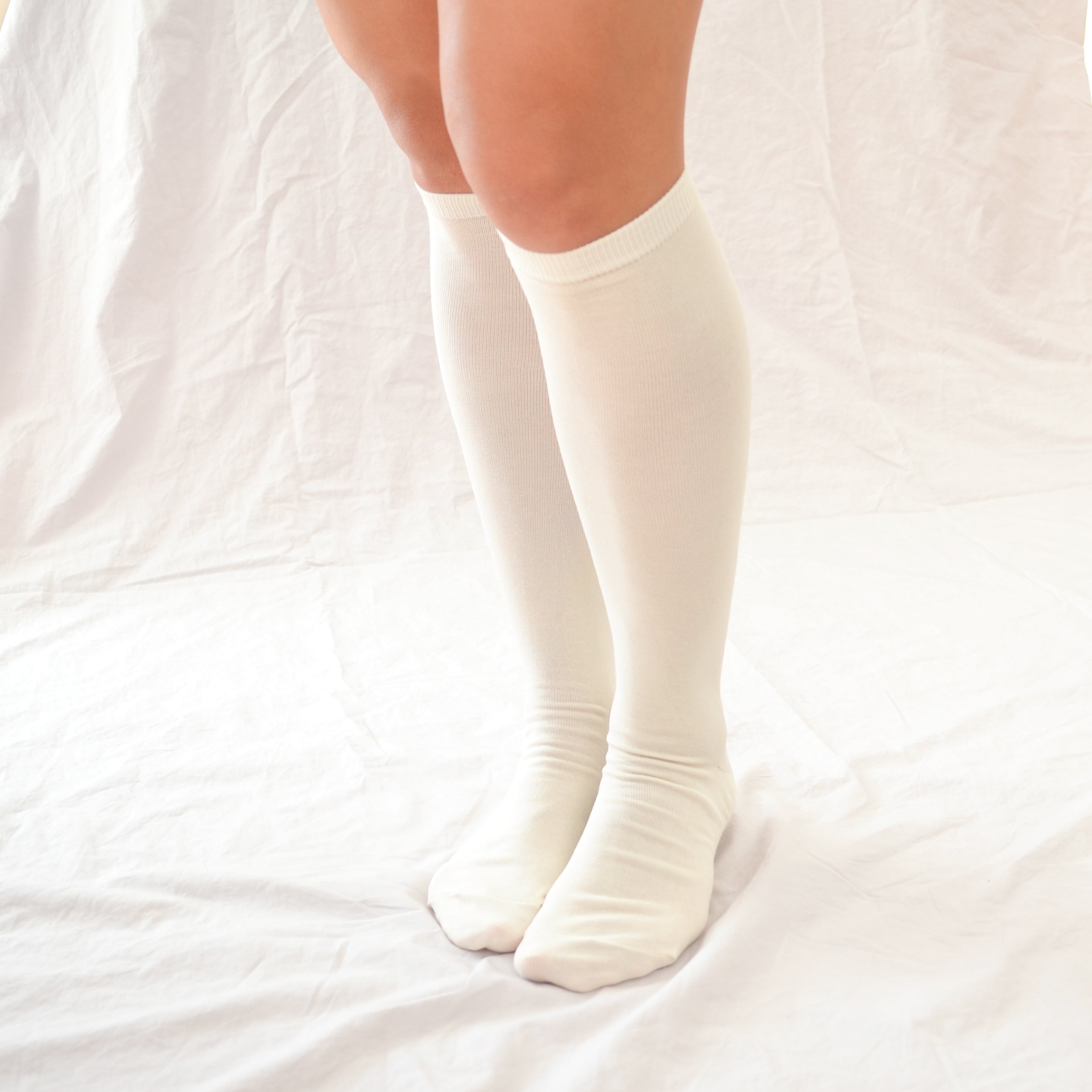 Elevate your style with our knee-high socks in classic grey, cream, and black. Luxuriously crafted for durability, these socks add a chic touch to any look. Made in South Korea. Small size (US women’s shoe size: 4-10.5)