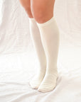 Elevate your style with our knee-high socks in classic grey, cream, and black. Luxuriously crafted for durability, these socks add a chic touch to any look. Made in South Korea. Small size (US women’s shoe size: 4-10.5)
