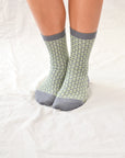 Pine mid-crew socks: cozy and shimmering, textured design with glittering thread in elegant beige and grey hues. Small size (US women’s shoe size: 4-8)