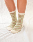 Pine mid-crew socks: cozy and shimmering, textured design with glittering thread in elegant beige and grey hues. Small size (US women’s shoe size: 4-8)