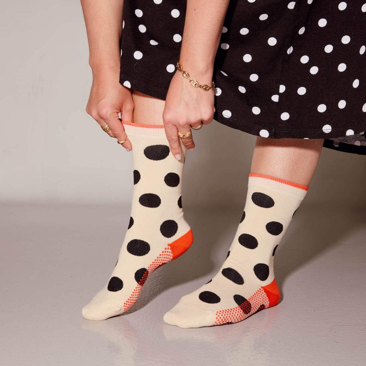 Person wearing polka dot socks with a plain background