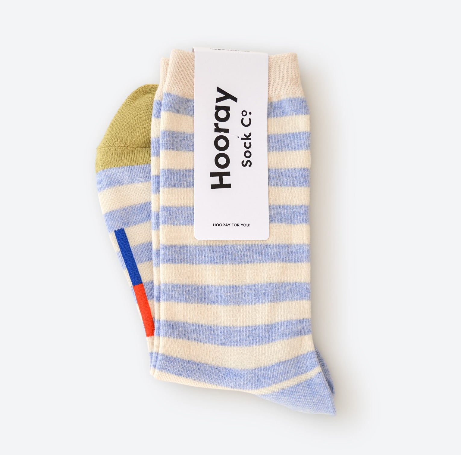 A delightful photograph showcasing our Greenwich Hooray Socks, a perfect blend of comfort and style. These crew socks feature a classic light blue and white stripe pattern with signature color bars. Crafted with 80% cotton and 20% spandex, they offer a lightweight and cozy feel. Made in South Korea, these unisex socks are available in two sizes: Large (Men's 8-12) and Small (Women's 4-10). Machine washable, no ironing needed; simply line dry for best results.