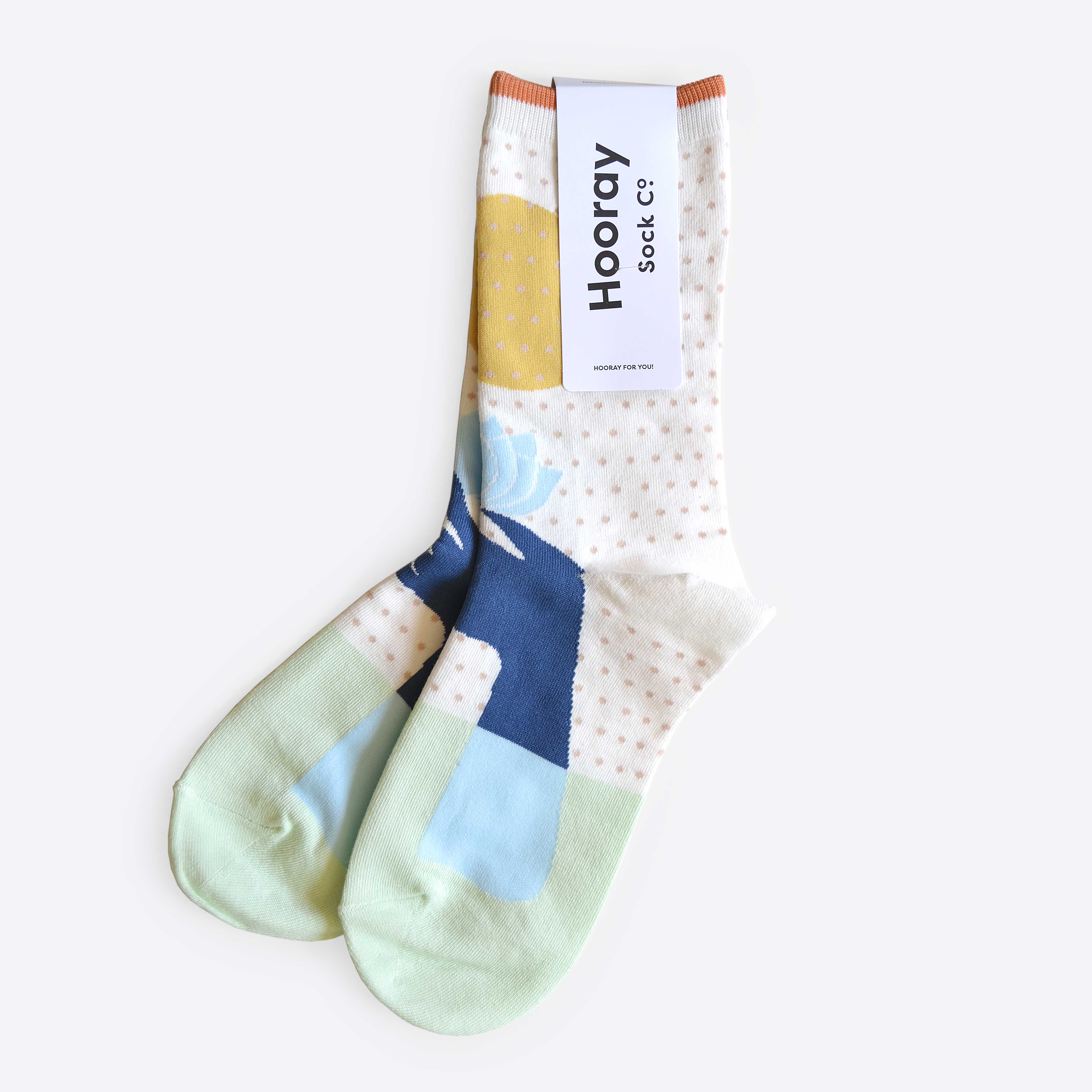 Hooray Sock Co. Lotus Crew Socks. Fun, lightweight, cozy with blue and gold lotus illustration. Crew length, 80% cotton, 20% spandex.