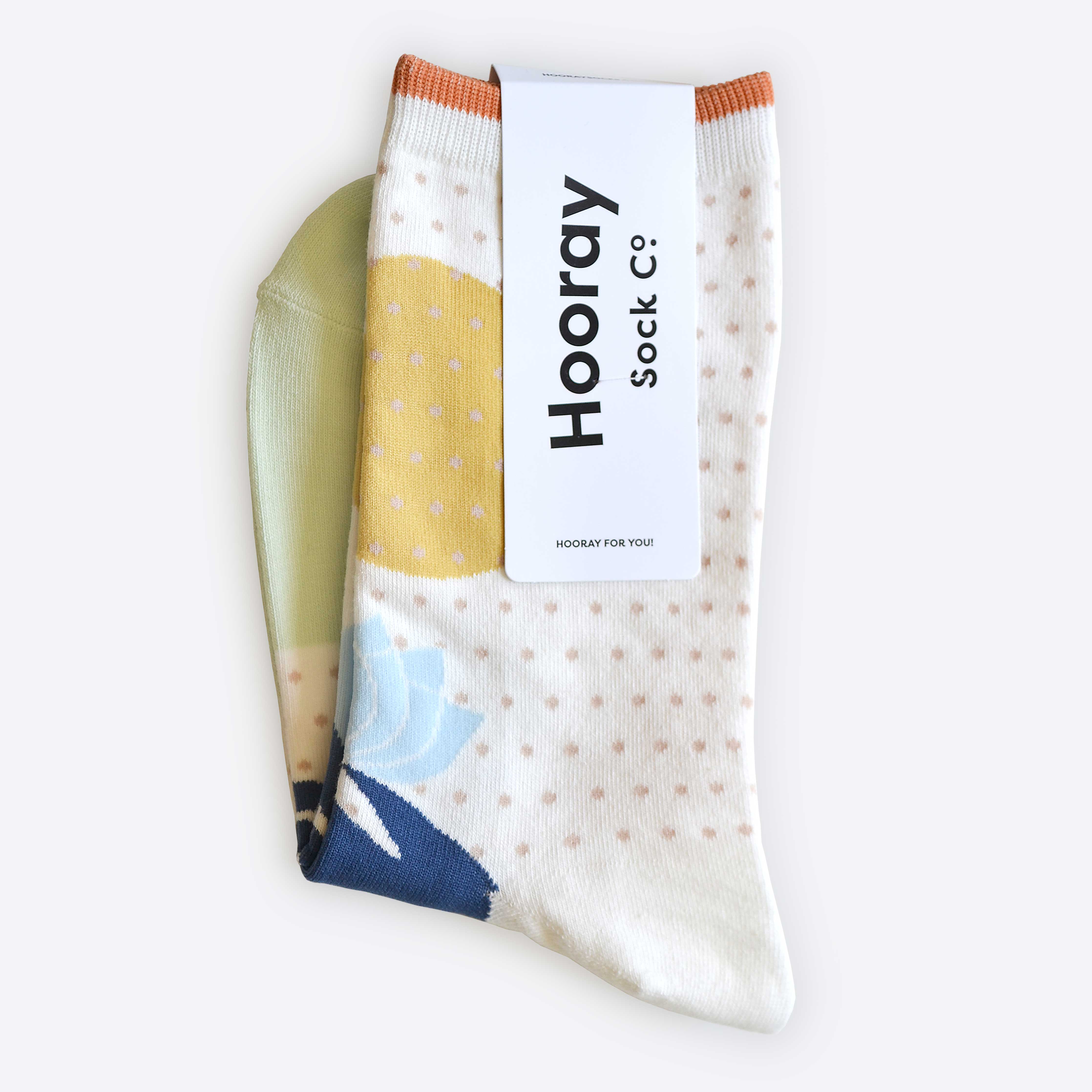 Hooray Sock Co. Lotus Crew Socks. Fun, lightweight, cozy with blue and gold lotus illustration. Crew length, 80% cotton, 20% spandex.